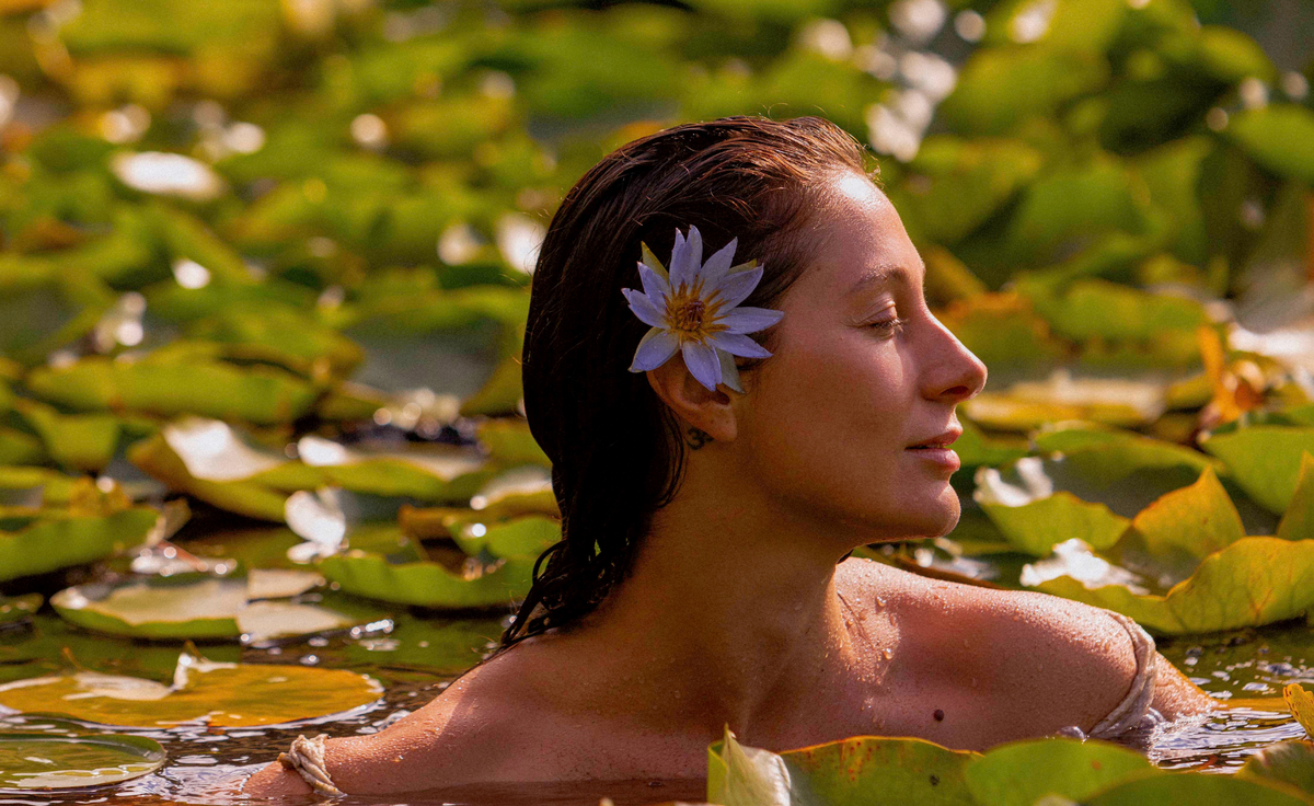 Blue lotus woman swimming in lotus garden musing glowing