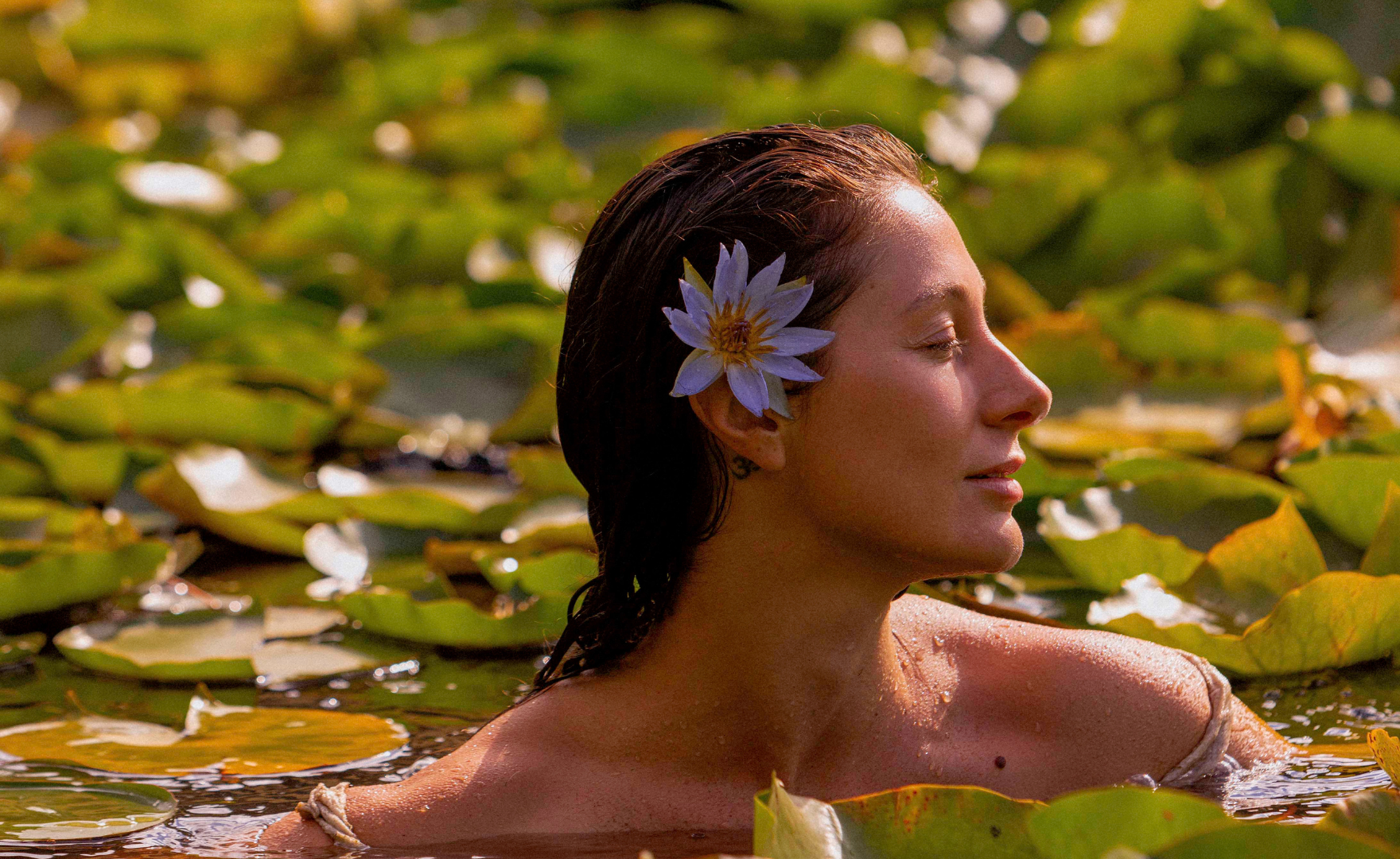 Blue lotus woman swimming in lotus garden musing glowing 