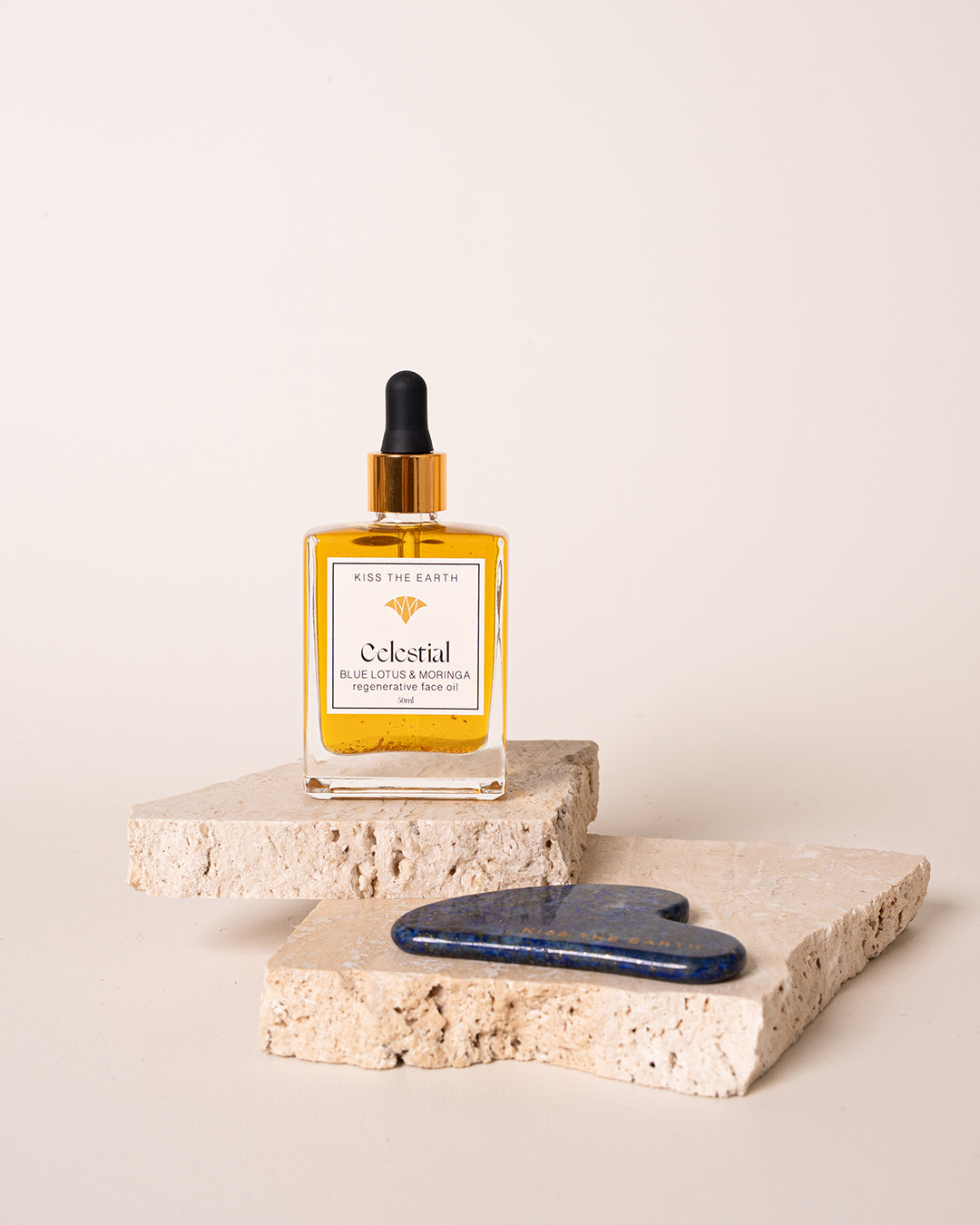 Yellow bottle with dropper labeled 'Celestial' on a stone surface with a white background